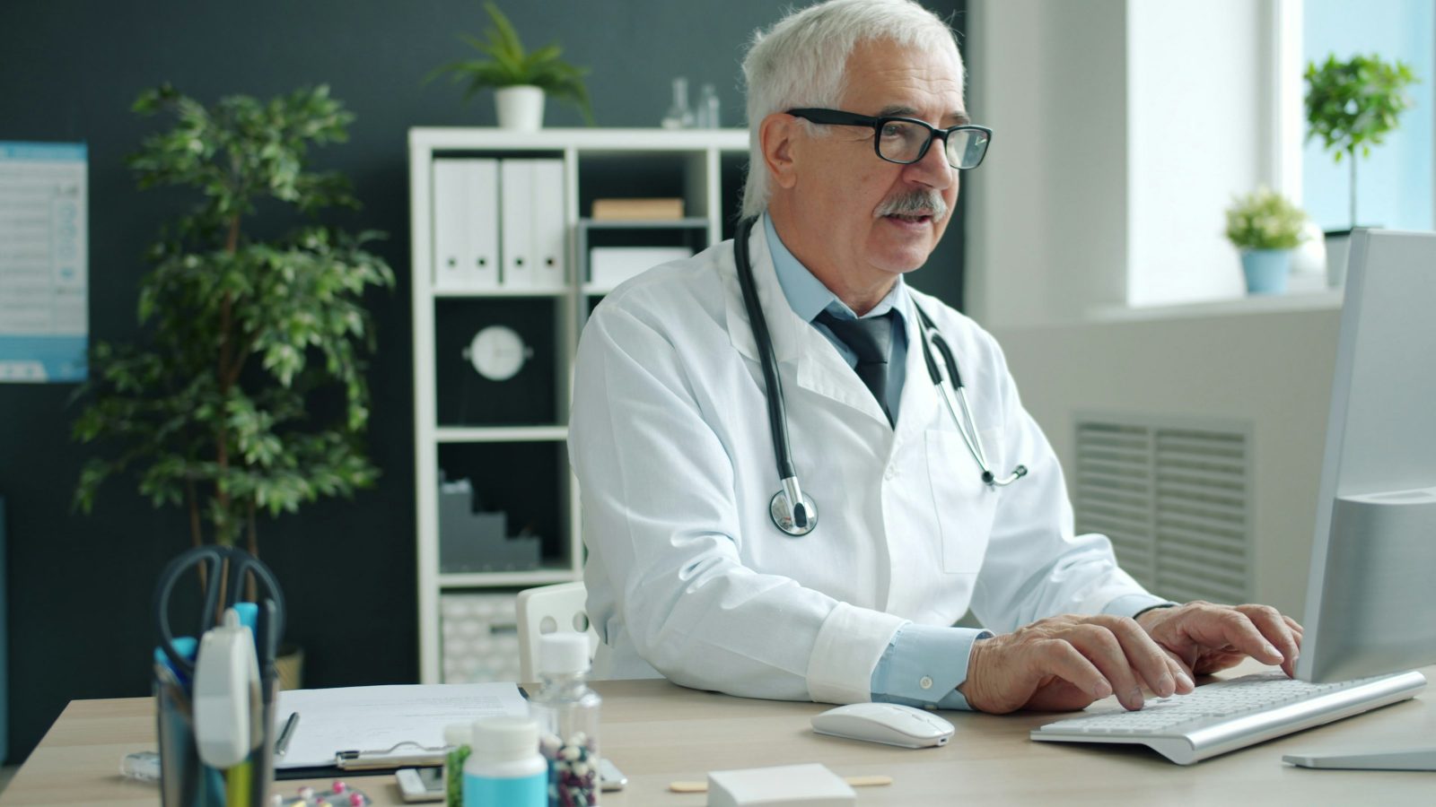 Medical billing professional reviewing claims at a desk